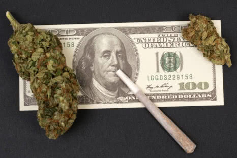 cannabis on hundred dollar bill with joint