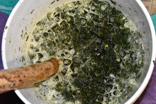 Stirring Together the Cannabis, Ice and Water in bucket for Bubble Hash making